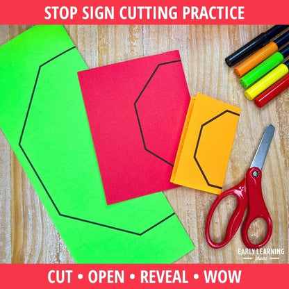 Bright green, red, and yellow folded paper with black outline stop signs, red scissors, and markers on wood surface for