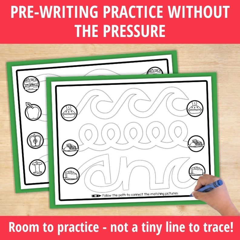 Child's hand holding blue crayon on wide curved line tracing path with apple-themed matching pictures in circles