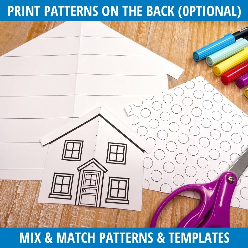 Fold-and-cut house template with window patterns and door outline beside colorful markers and purple scissors on wood surface