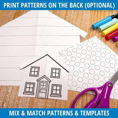 Fold-and-cut house template with window patterns and door outline beside colorful markers and purple scissors on wood surface