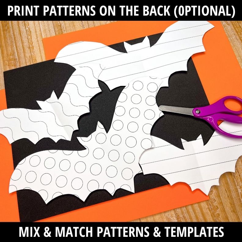 Fold-and-cut bat template with black wing shapes, white body with circle patterns, and purple scissors on wood background